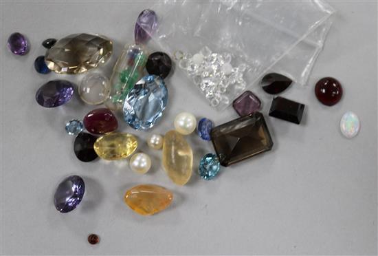 A quantity of unmounted gem stones including cabochon ruby etc.